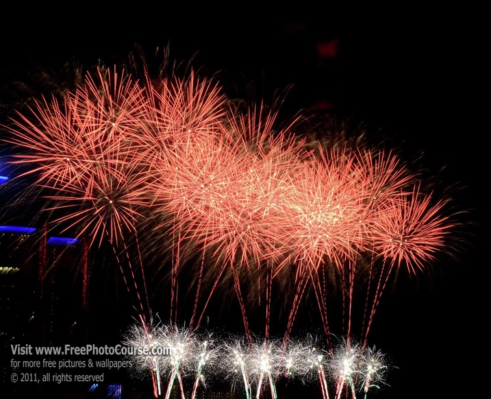 Picture of fireworks display over the Detroit River between Detroit, Michigan and Windsor, Ontario, Canada, during the annual fireworks display celebrating the freedom and friendship between the USA and Canada; © 2011, Stephen Kristof for FreePhotoCourse.com 