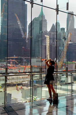 Picture of a woman looking out the large glass paines of the World Financial Center, NYC at construction of the new Freedom Center at Ground Zero.  Photo Credit: Joseph Constantino; Selected as the best of submissions for July, 2011. Published on FreePhotoCourse.com's Contributor's Gallery.  All rights reserved. 