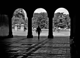 Picture if a person walking through an silhouetted archway near the Bathesda Pool, New York City.  Photo Credit: Joseph Constantino.  Selected as the best of entries for July 2011 in the FreePhotoCourse.com Contributor's Gallery.  All rights reserved.