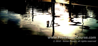 Picture of distorted reflection in curbside puddle.  Visit www.FreePhotoCourse.com for free photography tips, lessons, pictures and more!