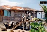 Cool picture of a shack house on stilts on a Caribbean island. Find more cool pictures and wallpapers at FreePhotoCourse.com. © 2011, all rights reserved. 