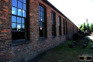 Picture of the external side of a factory, showing old brick and windows. Download free pictures and wallpapers.  © 2011, FreePhotoCourse.com, all rights reserved. 