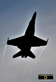 Picture of an F18 Hornet fighter jet silhouetted against a blue sky. © 2011, FreePhotoCourse.com, all rights reserved.  Free high-res desktop wallpapers and pictures.  