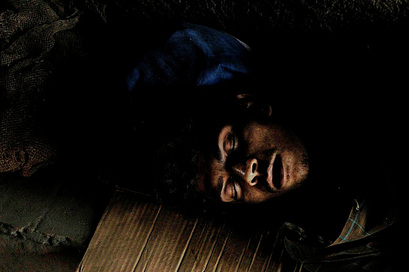 Interesting picture of a man sleeping on a piece of cardboard.  The lighting on his face brings out an interesting contour and evokes a feeling of compassion.   Part of the Photographer Profiles series at FreePhotoCourse.com. © 2010, Soham Gupta, all rights reserved.  
